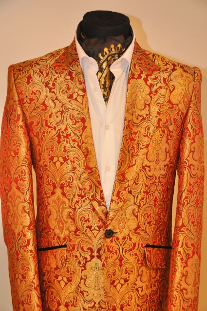 Bold print suit jacket dressed with patterned cravat style scarf designed by Julien Trivedi*