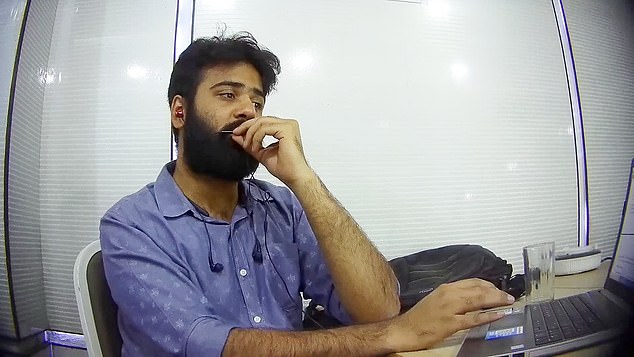 Conmen working in an office in Ahmedabad, India pose as HMRC officials and tell Britons they owe tax and face arrest and imprisonment if they do not pay up immediately. Pictured is Samkit Jain who spoke to an elderly gentlemen over the phone and said: 'Sir, we just wanted to know if you received the yellow slip regarding your case? Your case for tax fraud'